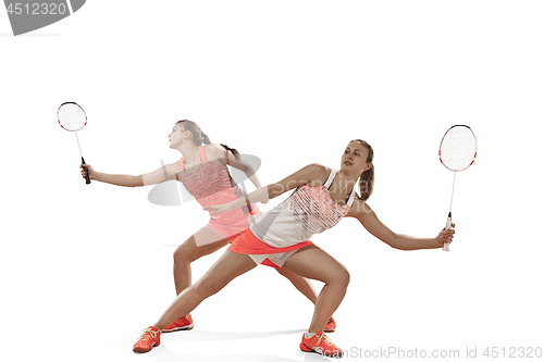 Image of Young women playing badminton over white background