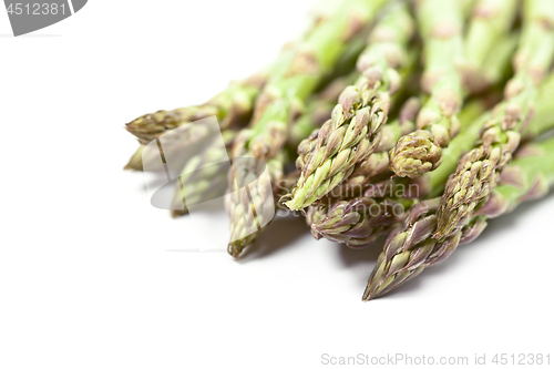 Image of Bunch of fresh raw garden asparagus closeup on white background.