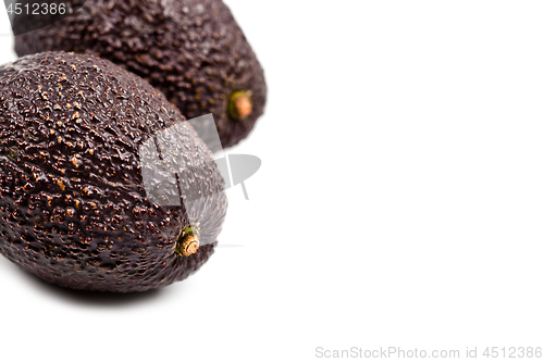 Image of Two fresh organic avocado closeup on white background.