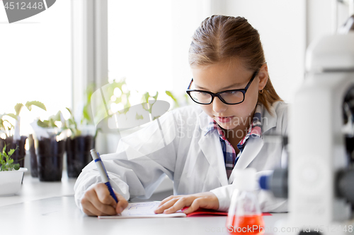 Image of girl studying chemistry at school laboratory