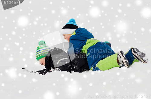 Image of happy little boys playing outdoors in winter