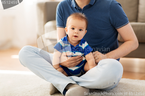 Image of baby boy with father at home