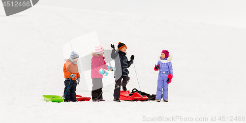 Image of happy little kids with sleds in winter
