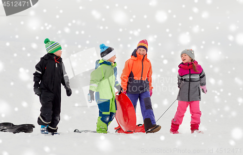 Image of happy little kids with sleds sledging in winter