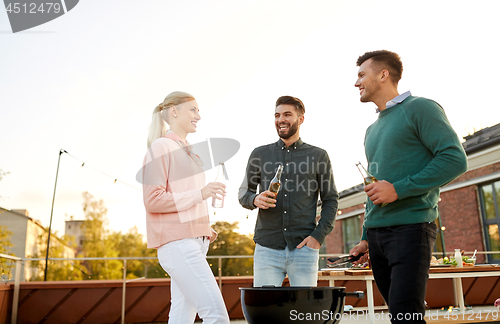 Image of happy friends having bbq party on rooftop