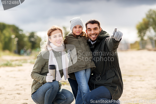 Image of happy family outdoors in autumn