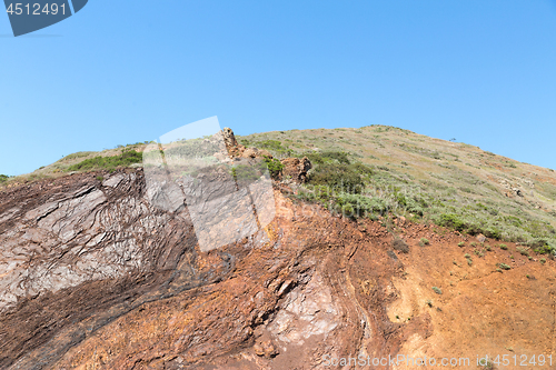 Image of close up of hill or mountain over blue sky