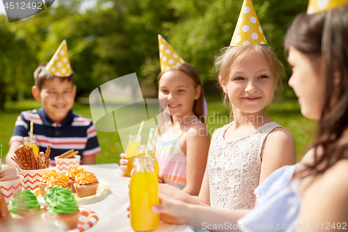 Image of happy kids on birthday party at summer garden