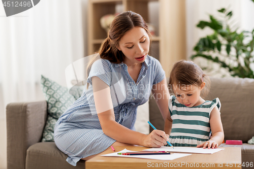 Image of pregnant mother and daughter drawing at home