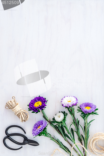 Image of Bouquet of asters on white wooden background