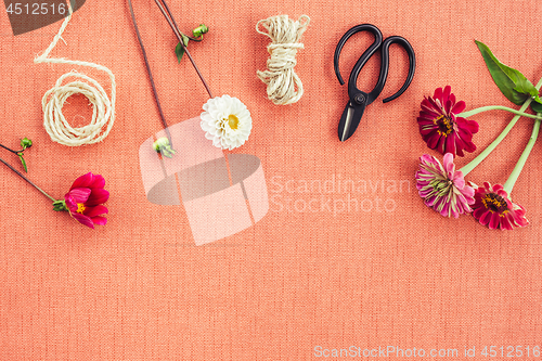 Image of Florist workspace on peach colored canvas background