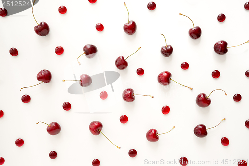 Image of Sweet cherries and cherry candies on white background