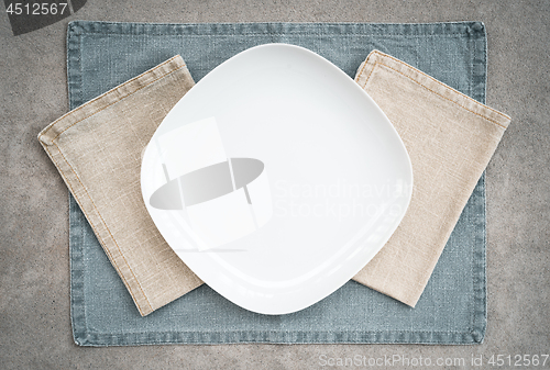 Image of White plate and linen napkins in pastel colors