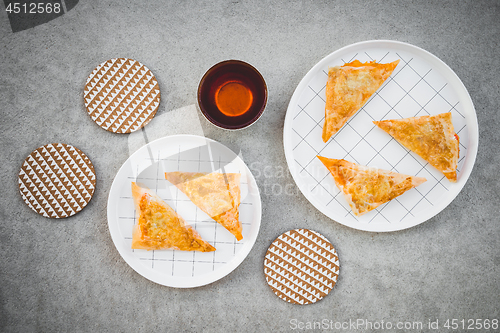 Image of Cheese pies and cup of tea on concrete background 