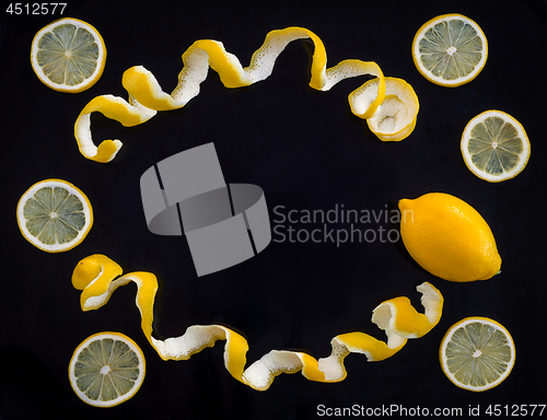 Image of Lemons and spiral peel on black background