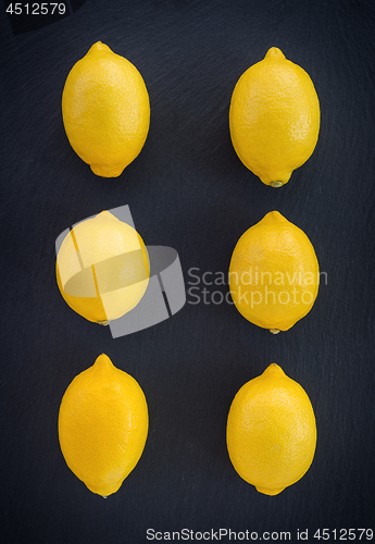 Image of Six fresh lemons on dark background