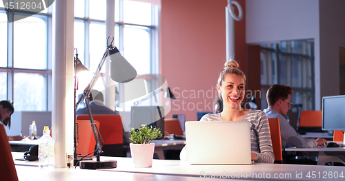 Image of businesswoman using a laptop in startup office