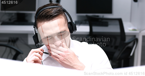 Image of male call centre operator doing his job