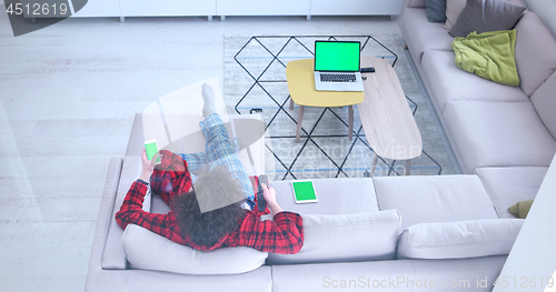 Image of Young couple on the sofa watching television