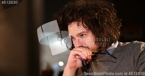 Image of man working on computer in dark office