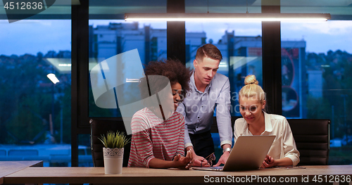Image of Multiethnic startup business team in night office