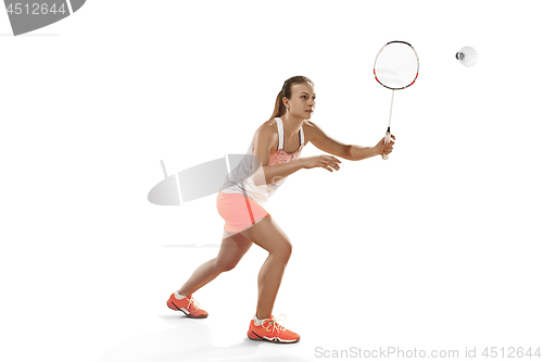 Image of Young woman playing badminton over white background