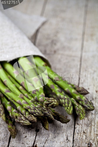 Image of Bunch of fresh raw garden asparagus closeup and linen napkin on 