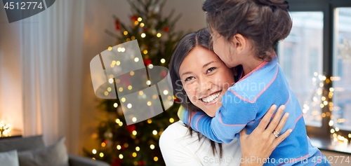 Image of happy mother hugging her daughter on christmas