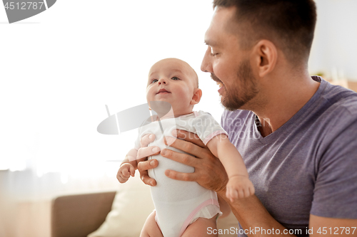 Image of close up of father with little baby girl at home