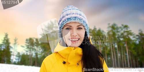 Image of happy young woman in winter clothes outdoors