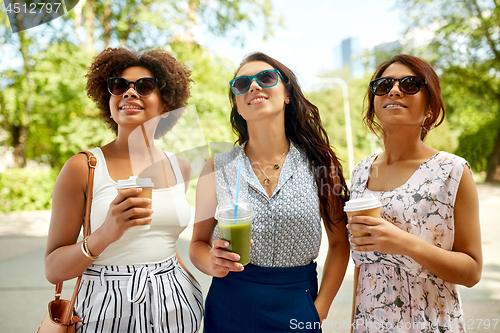 Image of happy women or friends with drinks at summer park