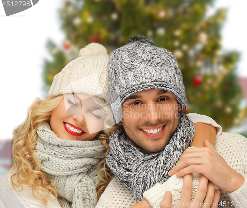 Image of happy couple hugging over christmas tree