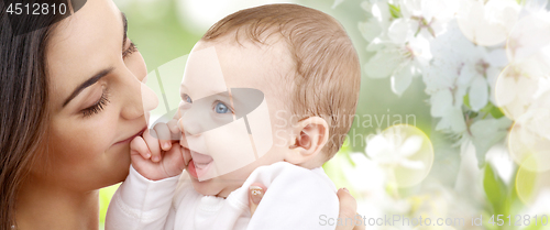 Image of mother with baby over cherry blossom background