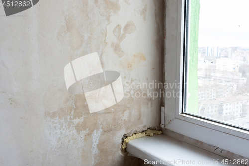 Image of Damp wall and poor installation of plastic windows