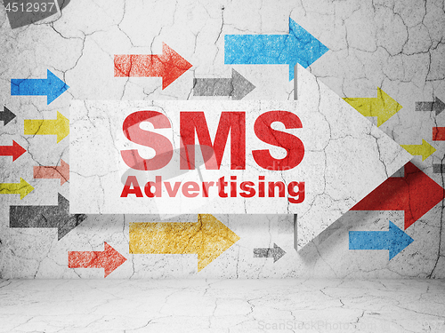 Image of Advertising concept: arrow with SMS Advertising on grunge wall background