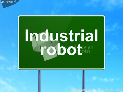 Image of Manufacuring concept: Industrial Robot on road sign background