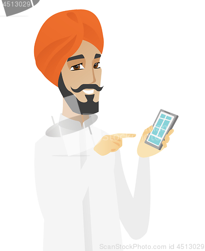 Image of Hindu businessman holding mobile phone.