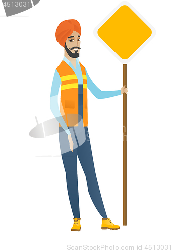 Image of Young hindu road worker showing road sign.