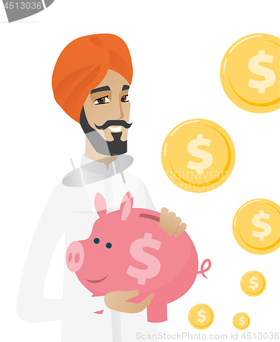 Image of Hindu businessman holding a piggy bank.