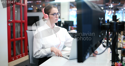 Image of businesswoman using a laptop in startup office