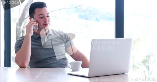 Image of businessman working using a laptop in startup office