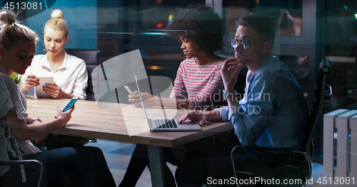 Image of Multiethnic startup business team in night office