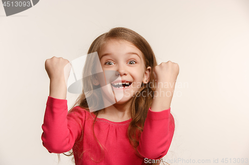 Image of Happy success teen girl celebrating being a winner. Dynamic energetic image of female model