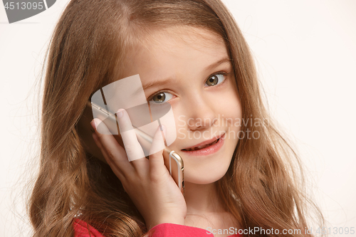 Image of The happy teen girl standing and smiling against white background.