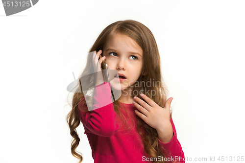 Image of The happy teen girl standing and smiling against white background.