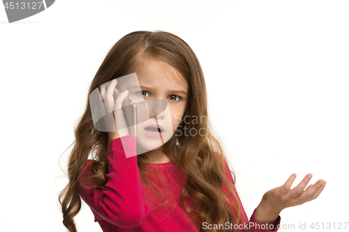 Image of The happy teen girl standing and smiling against white background.