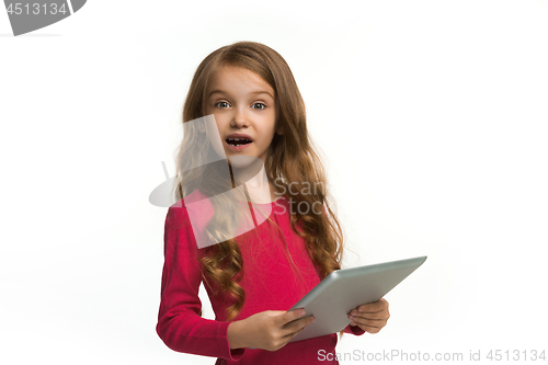 Image of Little funny girl with tablet on white background