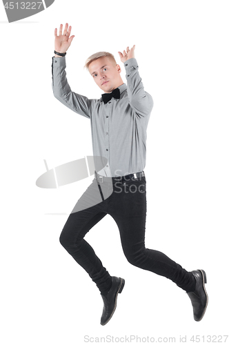 Image of Handsome man in shirt and bow-tie jumping