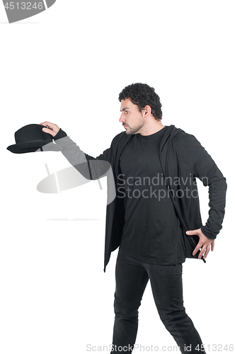 Image of Man in black with his black hat