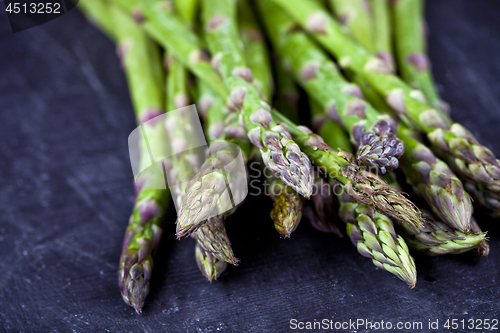 Image of Organic fresh raw garden asparagus closeup on black board backgr